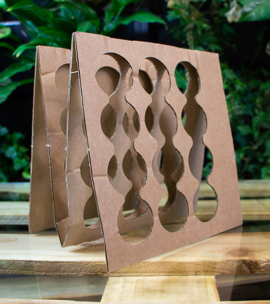 Cardboard standing in 'M' shape with congruent circular cut-out pattern
