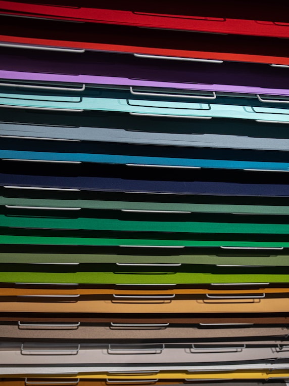 Multi-coloured paper dividers stacked on top of each other
