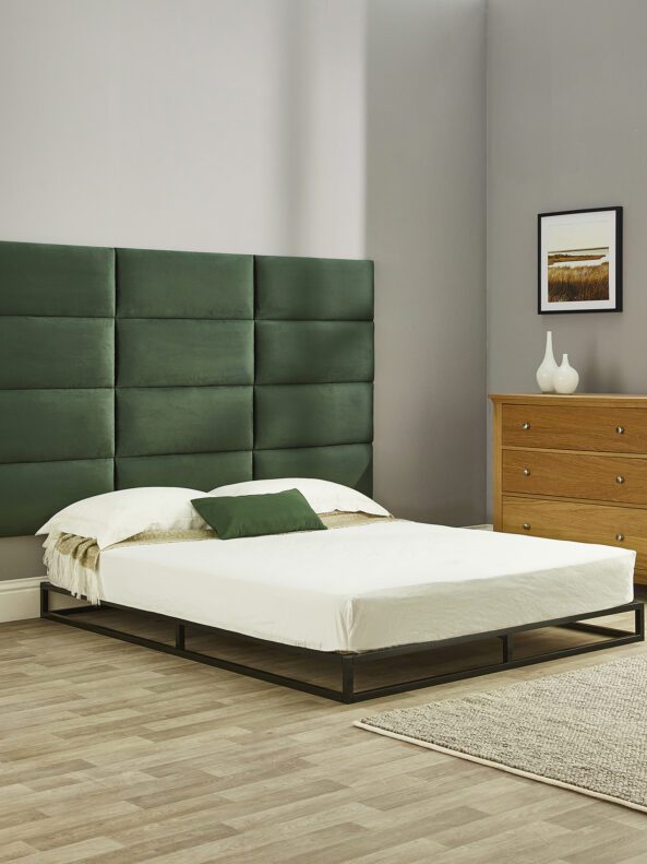 Bed with green Aspire wall-mounted panels behind it