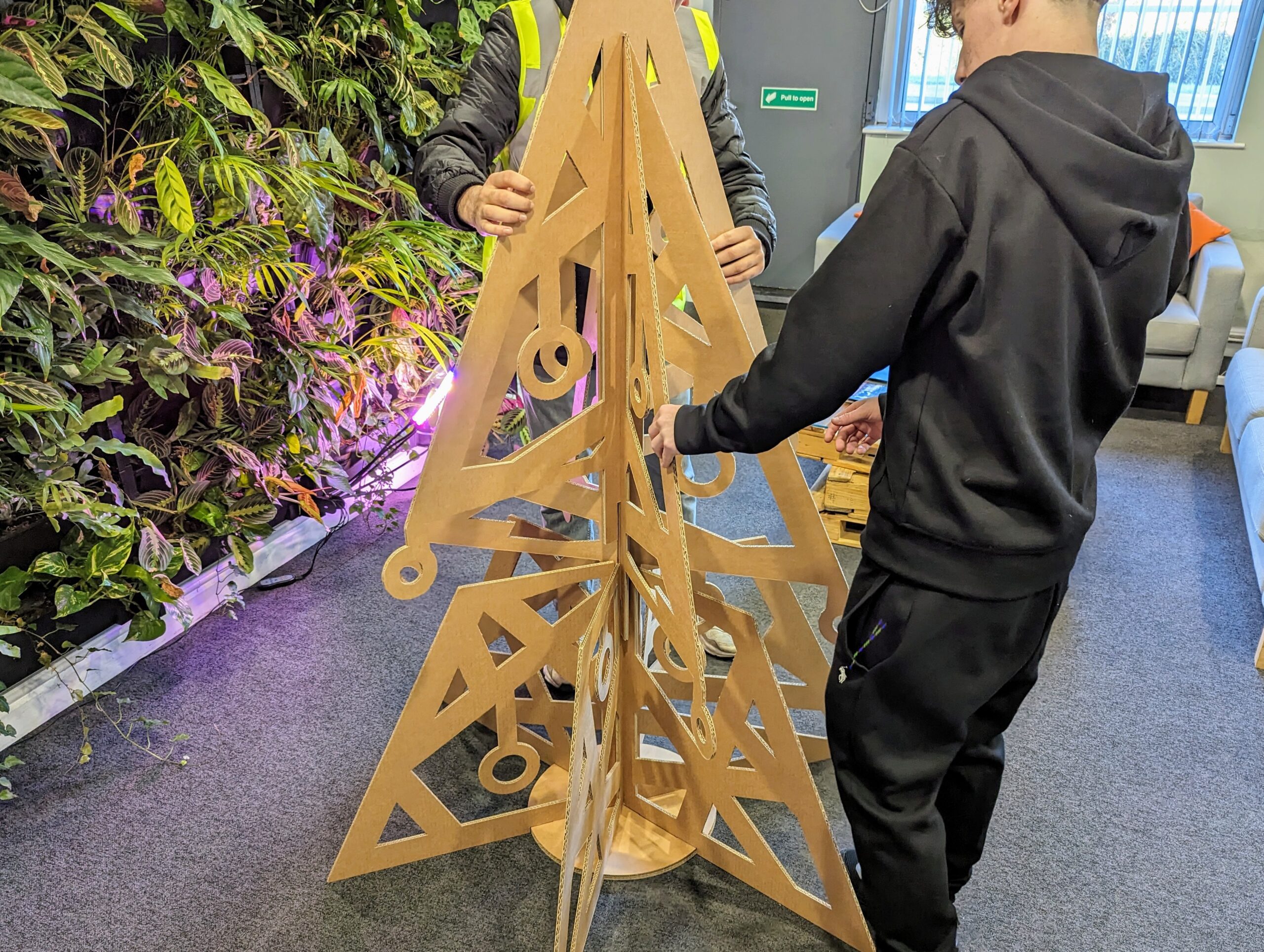 T-level students assembling our office cardboard christmas tree made with our CAD machine.