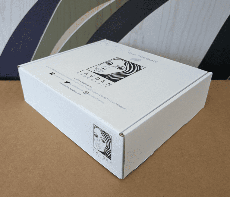 White branded box with Lauden Chocolate’s logo and contact details on it