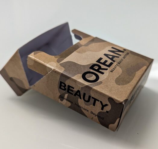 An open camouflage carton for Orean’s ‘Survival Kit’ beauty packaging featuring a self-locking, bespoke box design