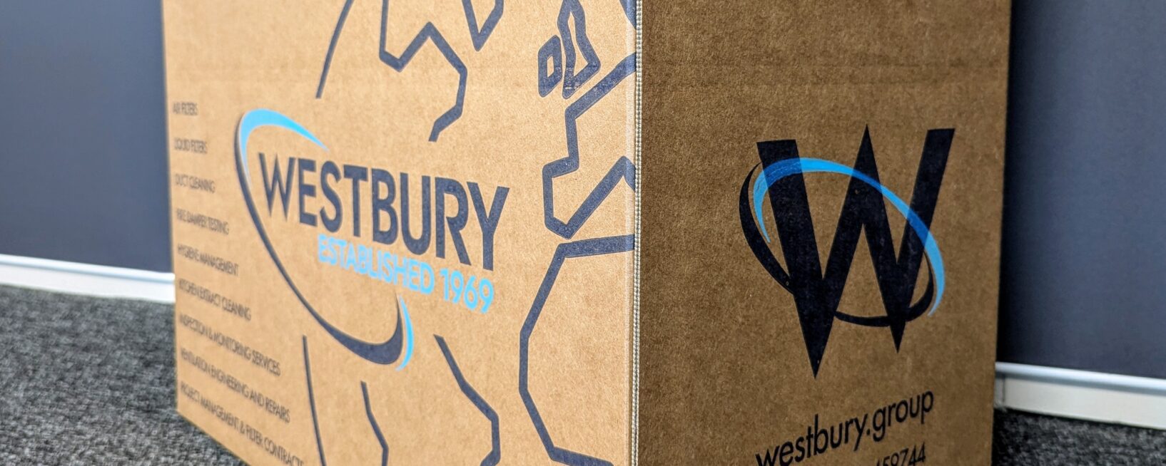 Side panels of the Westbury Group branded box with their blue logo and branding on it