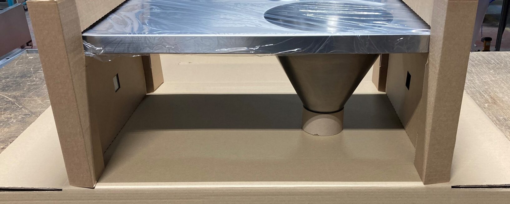 A bespoke packaging solution for a Pland Stainless sluice sink. The end caps are secured around the slop hopper body.