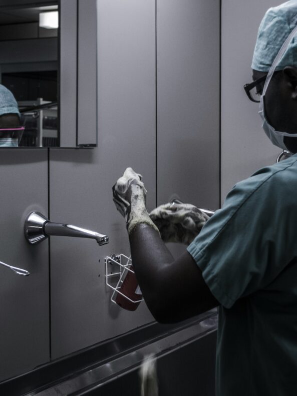 Surgeon washing hands in sink