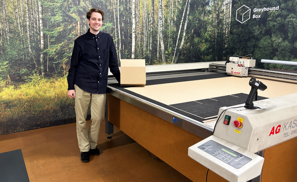 A member of Greyhound Box standing next to the CAD table in their new CAD area