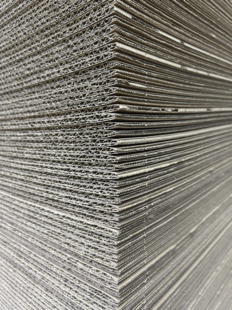 Stack of flat corrugated cardboard